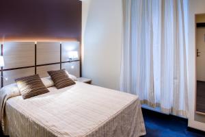 Postel nebo postele na pokoji v ubytování Hôtel La Source
