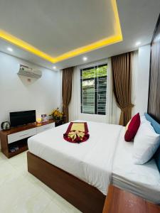 a bedroom with a large bed and a television at SAPHIA Hotel Hue in Hue +74 photos