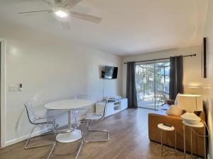 a living room with a table and chairs at Crescent Beach 1011 #1 in Sarasota