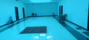 a swimming pool with chairs and a grate in the water at Brij Dham Ashram in Vrindāvan