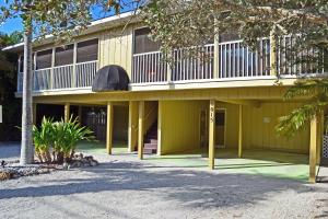 a yellow building with a balcony on top of it at Crescent Beach 1015 #2 in Sarasota