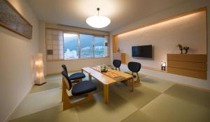 a living room filled with furniture and a tv at Yamagataya in Gero