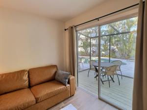 a living room with a couch and a patio with a table at Crescent Beach 1015 #2 in Sarasota