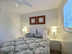 a bedroom with a bed with two lamps and a window at Crescent Beach 1015 #2 in Sarasota +16 photos