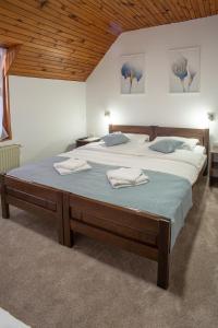 A bed or beds in a room at MB Hotel