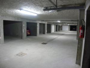 een lege parkeergarage met een auto erin geparkeerd bij Résidence Plein Soleil in Avrieux