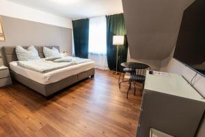 Ένα ή περισσότερα κρεβάτια σε δωμάτιο στο Hotel Ziegenhagen