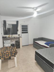 a bedroom with a bed and a ceiling fan at Pousada Lagoinha in Ubatuba
