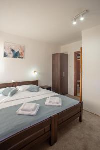 A bed or beds in a room at MB Hotel