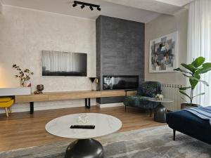 a living room with a couch and a table at Casa Maia in Eforie Sud