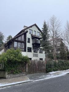 una casa blanca con una valla delante en Prime Home SOPOT HILL, en Sopot