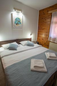 A bed or beds in a room at MB Hotel
