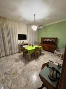 a living room with a green table and a couch at G & B House in Bari +33 photos