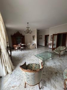 a living room with a glass table and a dining room at G & B House in Bari