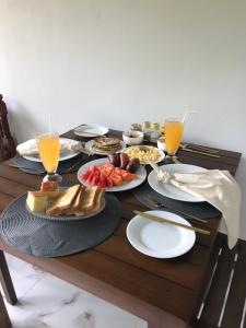 a table with plates of food and drinks on it at Stanley Villa One in Induruwa