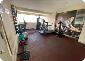a man is working out in a gym at Gold flat Manaíra 602 in João Pessoa