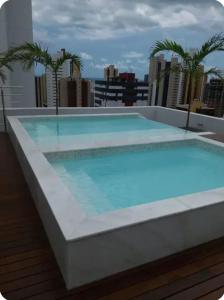 a large swimming pool on the roof of a building at Gold flat Manaíra 602 in João Pessoa +1 photo