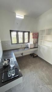 a kitchen with a counter and a sink in a room at VENUE DAYS homestays in Meenangadi