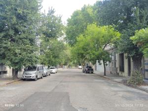 an empty street with cars parked on the side of the road at LoFt mANoLO in Montevideo