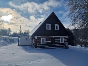a small house in the snow with snow covered at Roubenka Krkonoše - Adršpach in Radvanice
