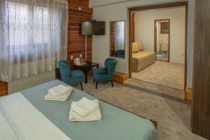A bed or beds in a room at MB Hotel