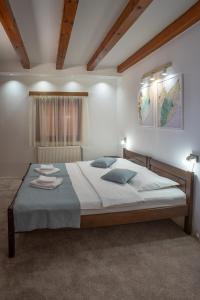 A bed or beds in a room at MB Hotel