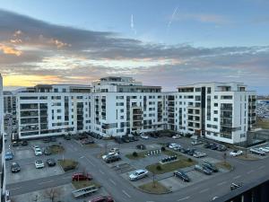 an aerial view of a parking lot with white buildings at Luxury Glam Apartments Coresi Mall Area in Braşov