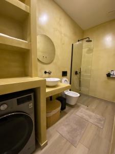 a bathroom with a sink and a toilet and a shower at Luxury Apartment in Makry Gialos in Ierápetra