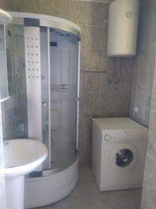 a bathroom with a shower and a toilet and a sink at Solara in Bar +29 photos