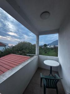 a balcony with a table and two chairs and a window at Solara in Bar