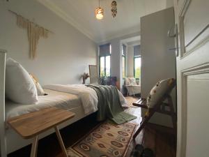 a bedroom with a bed and a table and a chair at Balat Boutique Hotel in Istanbul