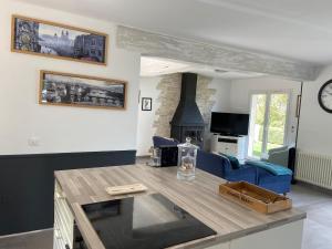 a living room with a table and a blue couch at Villa Monte Cassino in Tanneron
