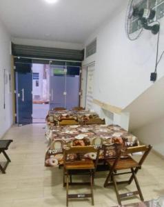a room with a row of beds in a room at Pousada MC in Aparecida