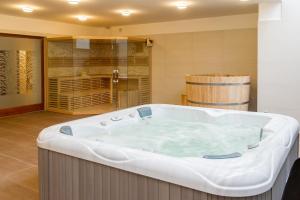 a large bath tub in a room with a wine cellar at BH Kristály in Debrecen