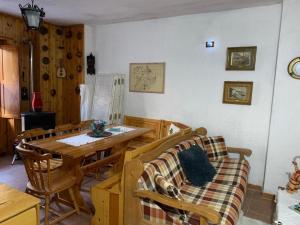 a dining room with a wooden table and chairs at Sweet Home in Palena