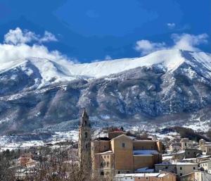a city with a mountain in the background with snow at Sweet Home in Palena