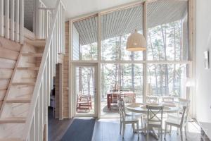 a dining room with a table and chairs and a large window at Kustavin Lootholma in Kustavi