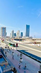 a group of people walking around in a city at Al Reem 1BR City View Pool Gym Family Biz Friendly Abu Dhabi in Mushayrib