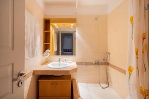 a bathroom with a sink and a shower at Sandy Beachfront House Ganema Serifos in Ganema +40 photos