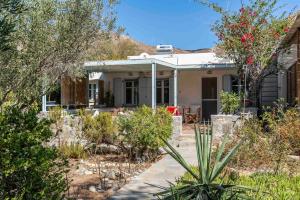 a house in the middle of a garden at Sandy Beachfront House Ganema Serifos in Ganema