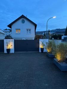 a white house with lights in a driveway at Casa Brocktega in Bestwig