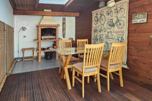 a dining room with a table and chairs and a fireplace at Casita Salpino in Sauzal