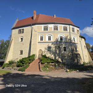 a large stone building with a red roof at City APART - FeWo Klimaanlage Whirpool Panoramafenster 5 Personen Kulturdenkmal Dessau-Roßlau in Dessau +81 photos