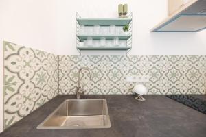 a kitchen with a sink and a wall at Great 2-room apartment in Mitte in Berlin