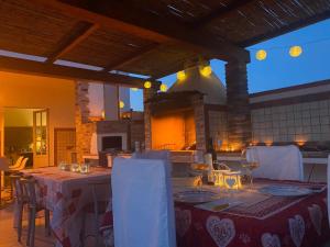 a dining room with a table with white chairs at Celeste's house in Giba