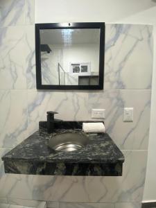 a bathroom with a marble sink and a mirror at Rincón del parana in Puerto Iguazú