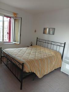a bedroom with a bed in a room with a window at La Casa sul lago - Appartamento Glicine - Parco della Majella in Civitella Messer Raimondo