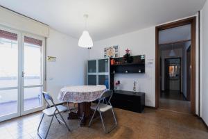 a dining room with a table and chairs at FARE BnB - Room Pappagnocca in Reggio Emilia
