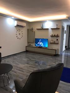 a living room with a television and a clock on the wall at Detached and luxury villa in kadriye in Belek