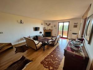 a living room with a couch and a table at Splendido Chalet in Camigliatello Silano